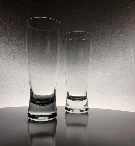 Vintage Saara Hopea beer glasses displayed elegantly on a table, showcasing their unique design and shape.