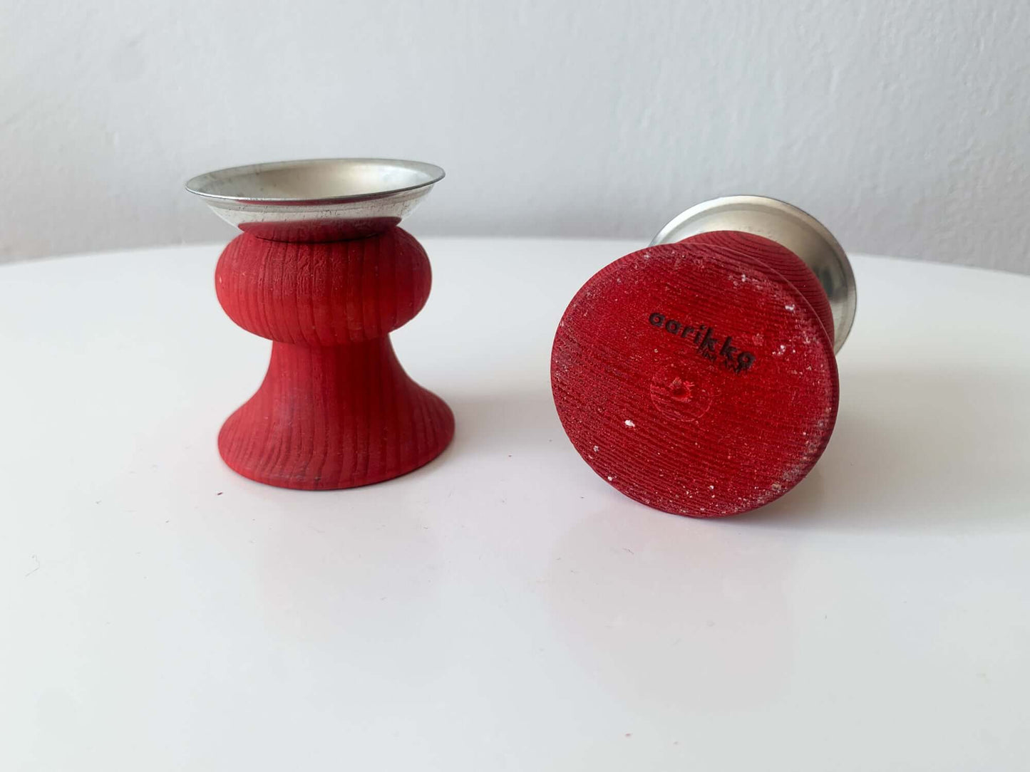 Pair of red wooden candle holders, Aarikka, Finland, 1970s