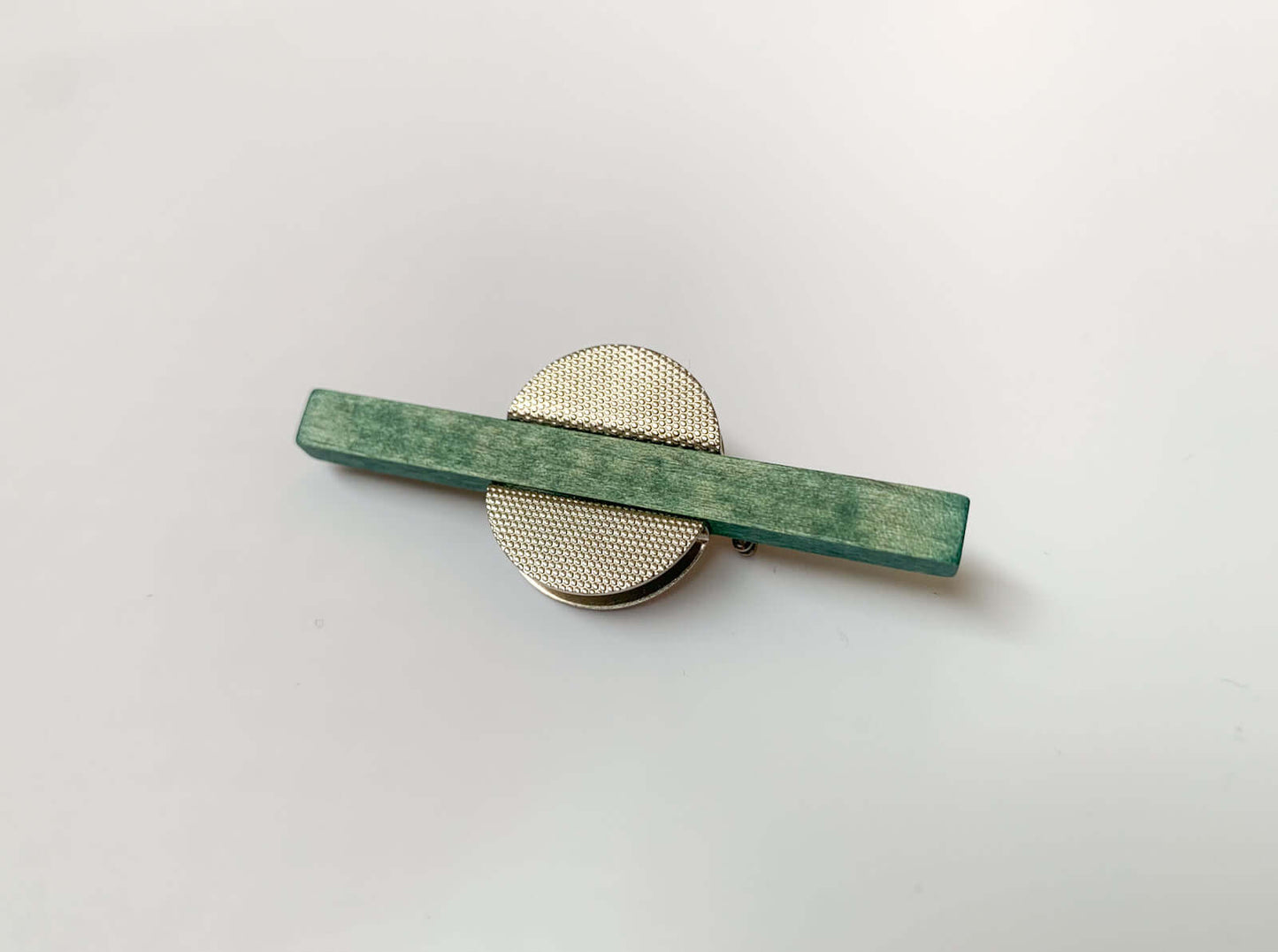 Green wood and metal brooch by Aarikka Finland
