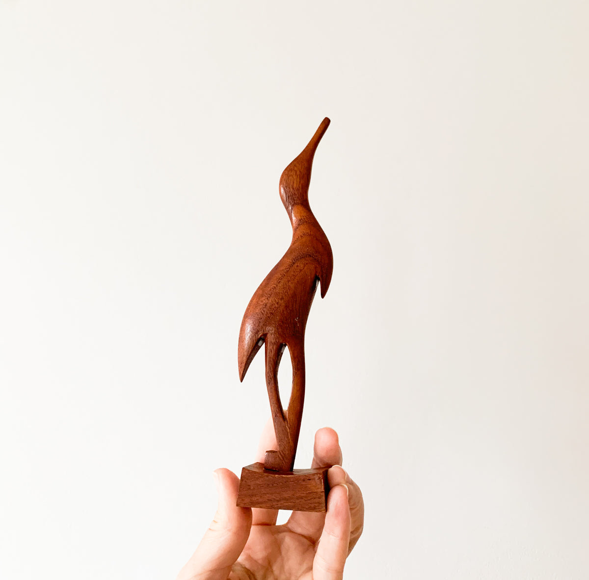 Teak heron figurine