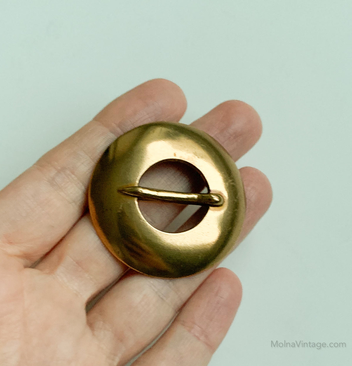 Circular bronze brooch by Kalevala