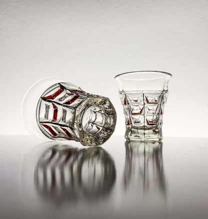 Vintage hand-painted shot glasses from Riihimäen Lasi, showcasing geometric design and delicate red decoration.