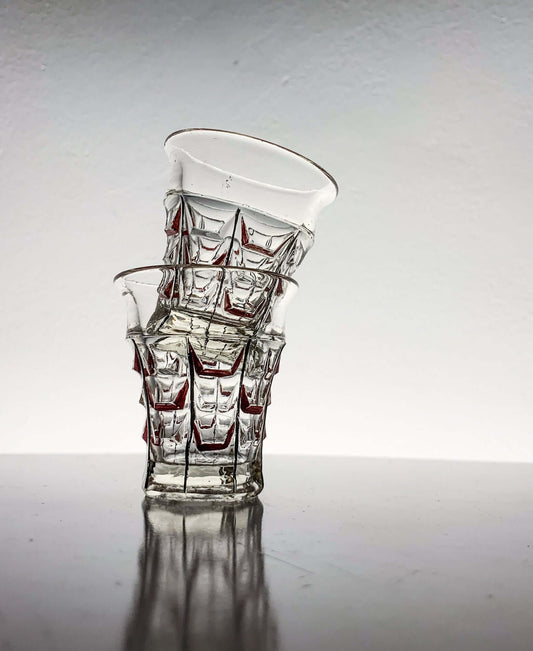 Vintage hand-painted shot glasses by Riihimäen Lasi, showcasing geometric design and red accents.