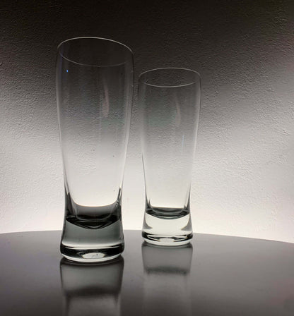 Vintage Saara Hopea beer glasses displayed elegantly on a table, showcasing their unique design and shape.