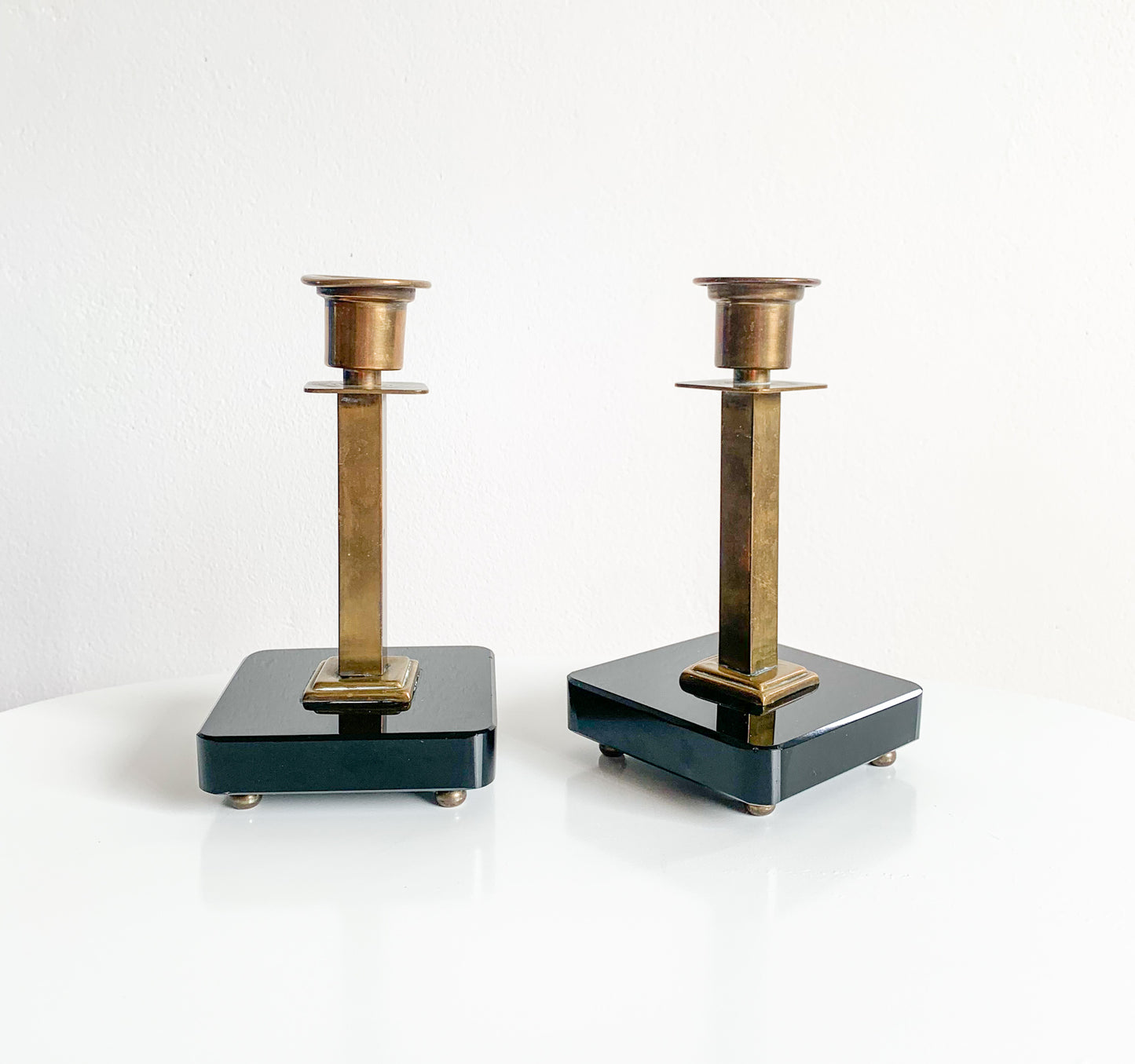 Pair of Swedish Art Deco brass & black glass candlesticks