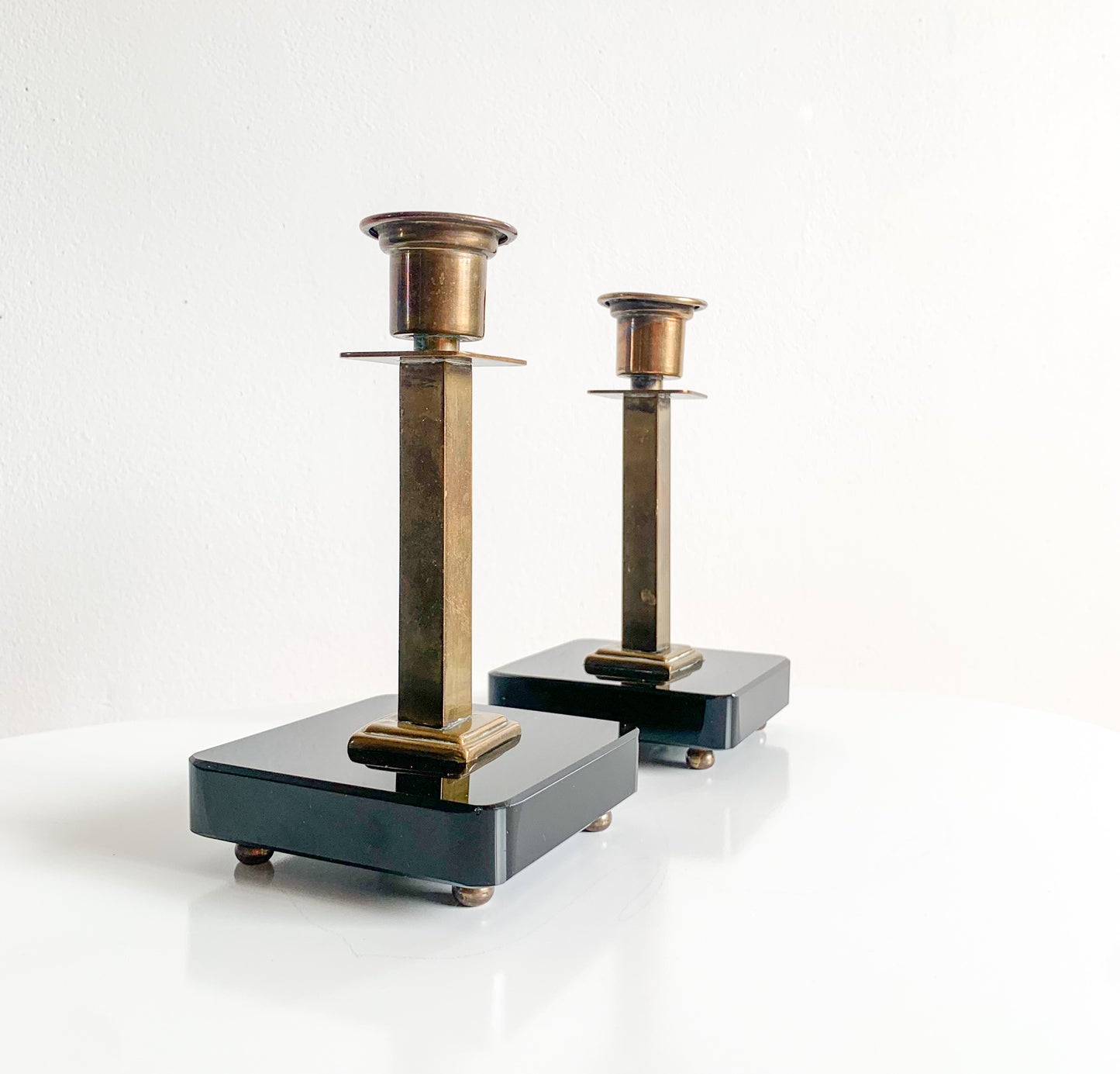 Pair of Swedish Art Deco brass & black glass candlesticks