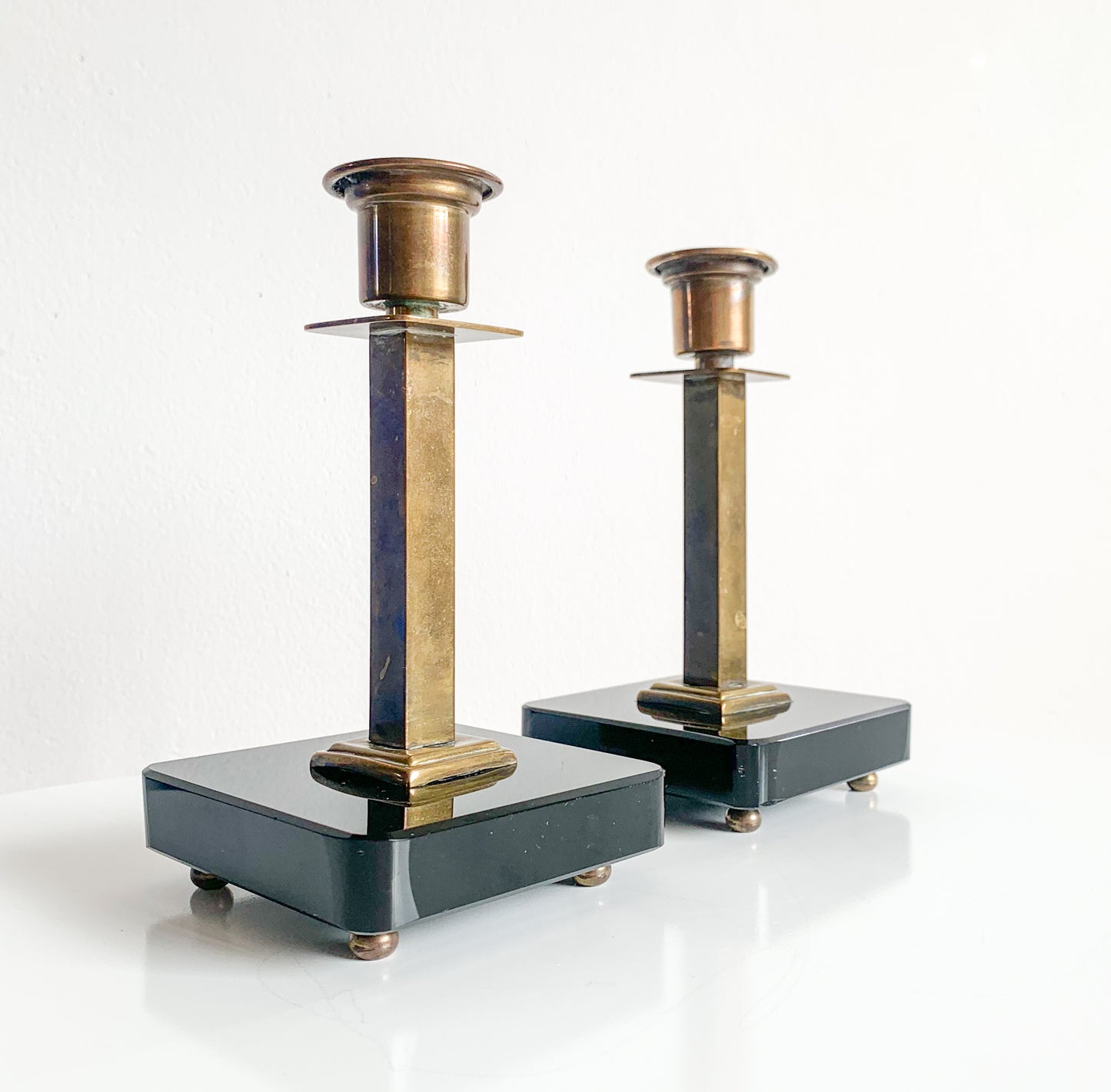 Pair of Swedish Art Deco brass & black glass candlesticks