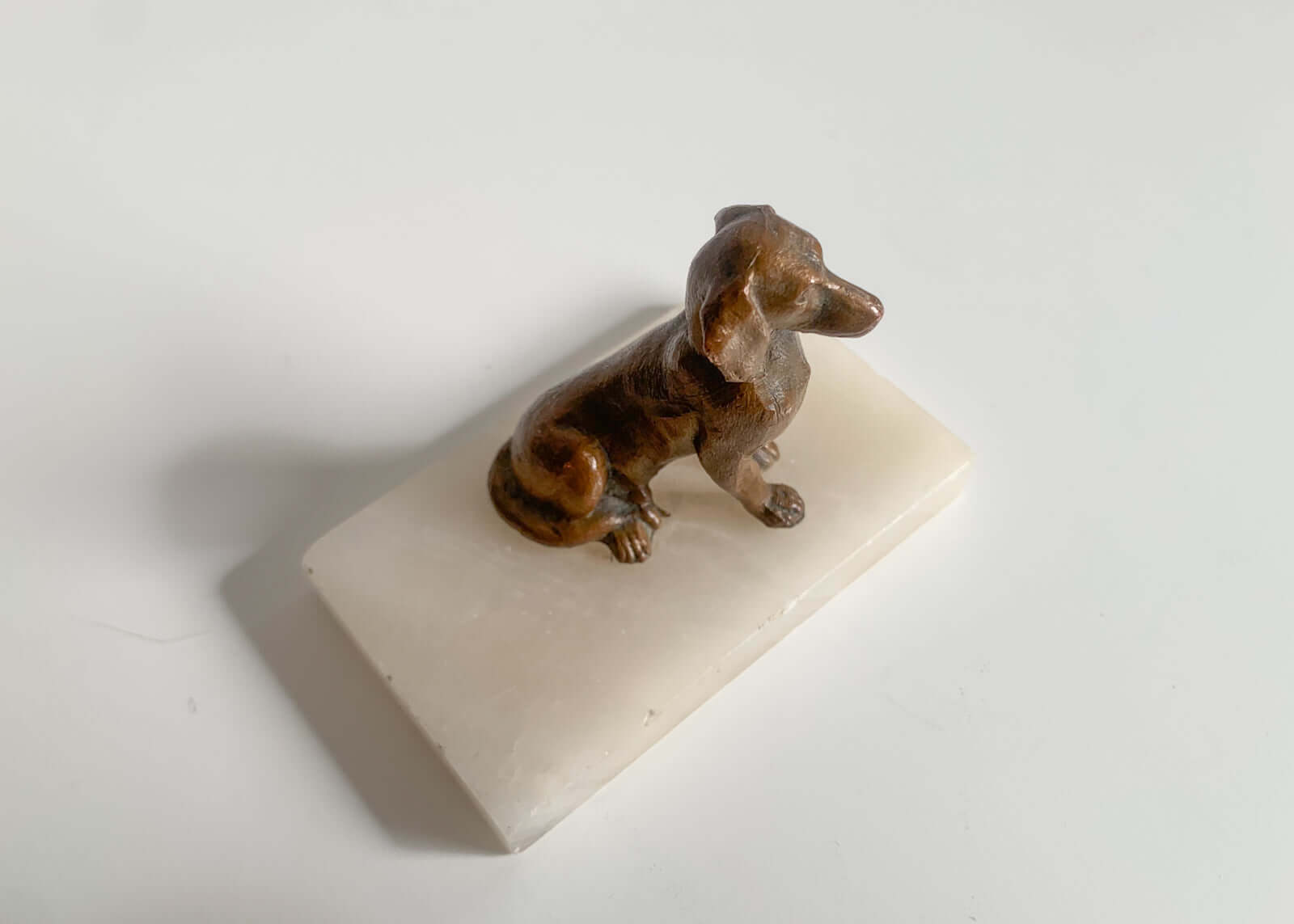 Sitting bronze dog figurine